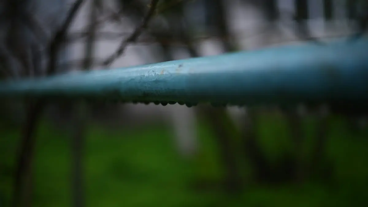 A blue water pipe beaded with drops of condensation - Leak Detection in Cherry Hill